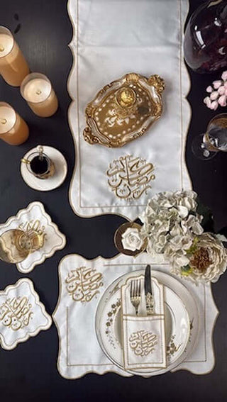 Ramadan Kareem Design Gold Placemat Set - Premium Fabric - 6 Persons - 19 Pieces on a table with candles and flowers.